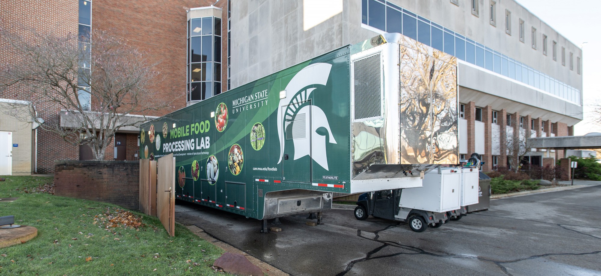 Michigan State University&rsquo;s mobile food processing lab is parked outside a campus building during a workforce training event.
